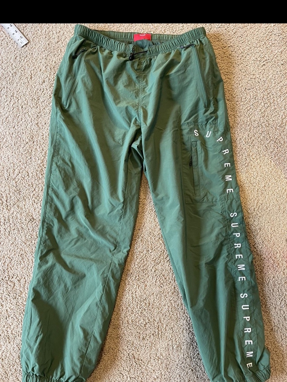 Supreme Green Mesh Athletic Shorts with Red Size Tag